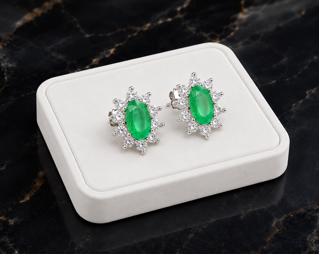 Natural emerald cluster stud earrings displayed on a luxury white jewelry tray