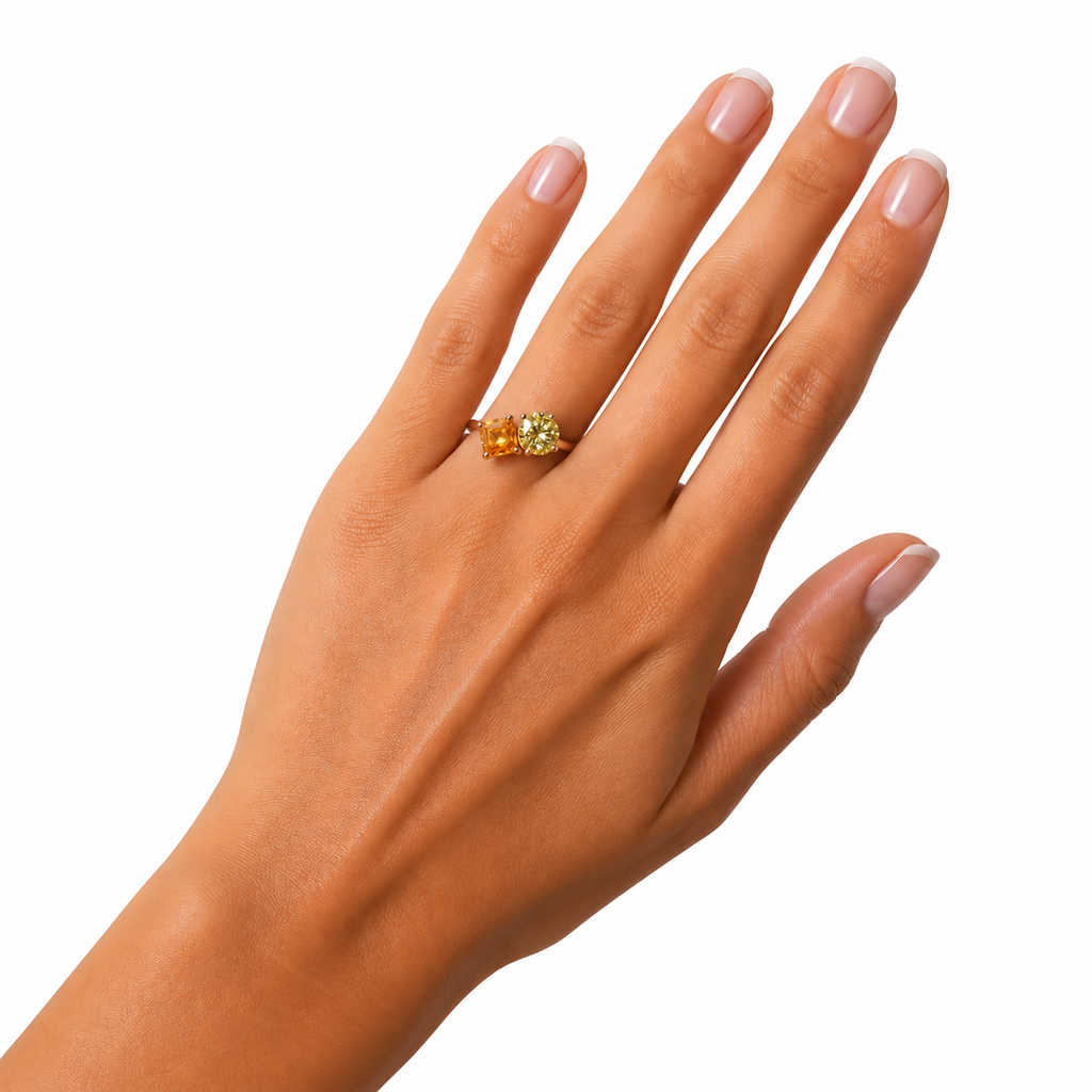 Two stone yellow moissanite ring featuring Asscher cut and round brilliant cut gemstones in rose gold plated 925 sterling silver on a white background