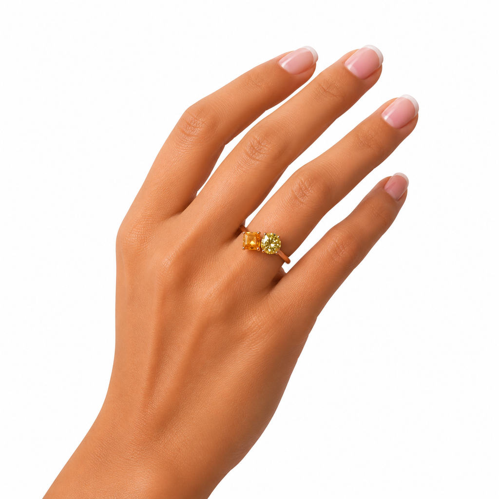 Two stone yellow moissanite ring featuring Asscher cut and round brilliant cut gemstones in rose gold plated 925 sterling silver on a white background