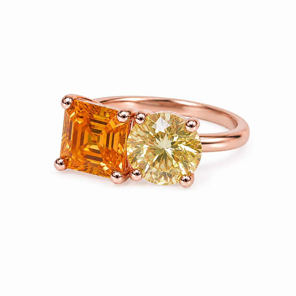 Two stone yellow moissanite ring featuring Asscher cut and round brilliant cut gemstones in rose gold plated 925 sterling silver on a white background