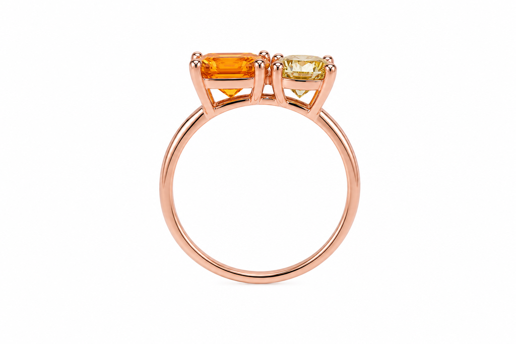 Two stone yellow moissanite ring featuring Asscher cut and round brilliant cut gemstones in rose gold plated 925 sterling silver on a white background