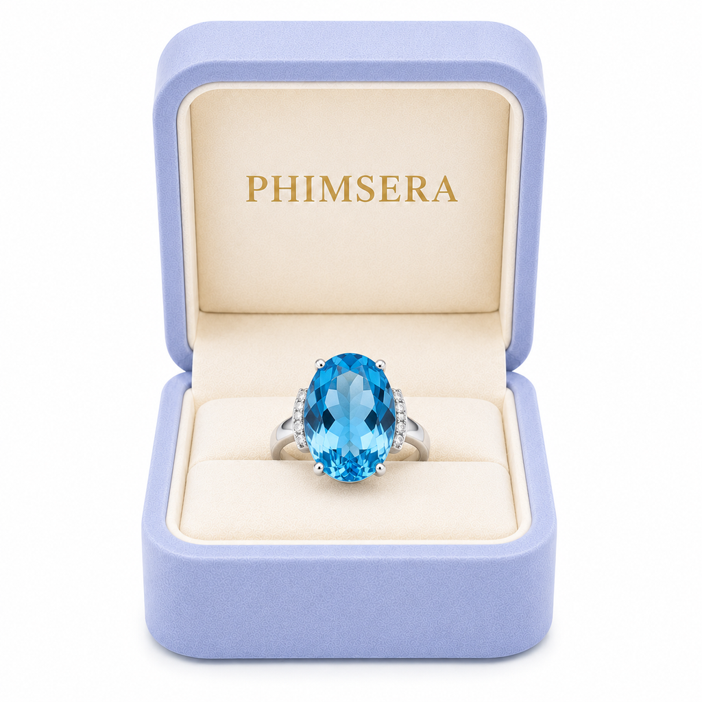 Natural Swiss Blue Topaz ring featuring a 12x16mm oval gemstone with cubic zirconia accents in platinum-plated sterling silver.