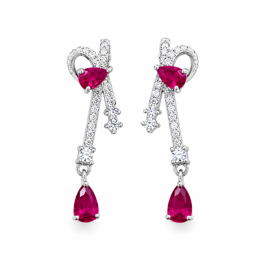 Natural ruby pear drop earrings with cubic zirconia accents in platinum plated 925 sterling silver on a white background.
