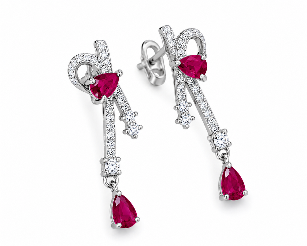 Natural ruby pear drop earrings with cubic zirconia accents in platinum plated 925 sterling silver on a white background.