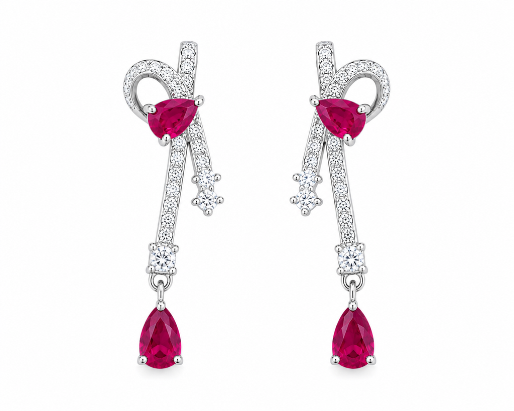 Natural ruby pear drop earrings with cubic zirconia accents in platinum plated 925 sterling silver on a white background.
