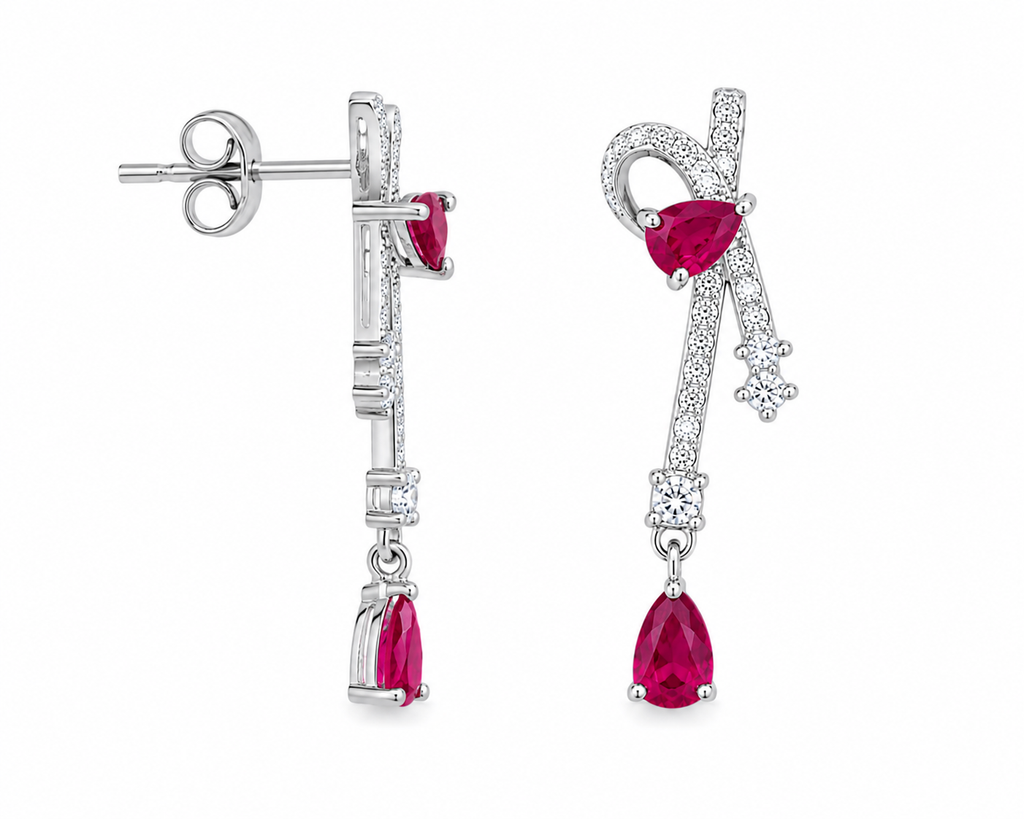 Natural ruby pear drop earrings with cubic zirconia accents in platinum plated 925 sterling silver on a white background.