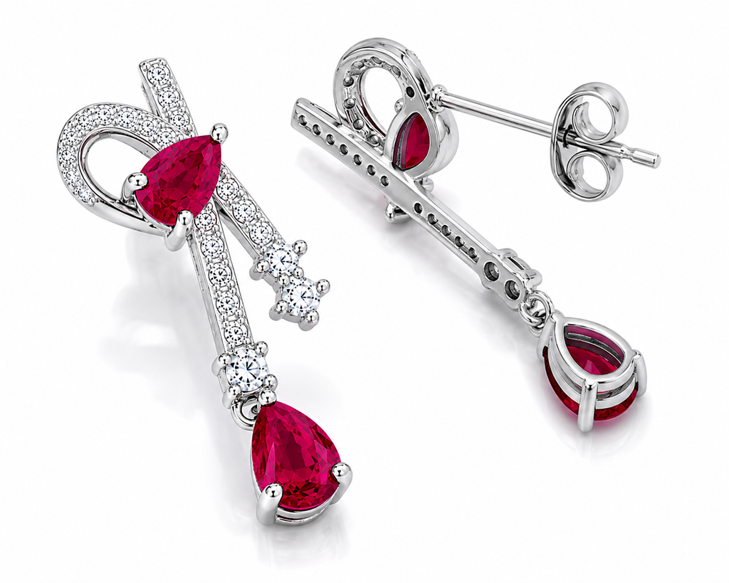 Natural ruby pear drop earrings with cubic zirconia accents in platinum plated 925 sterling silver on a white background.