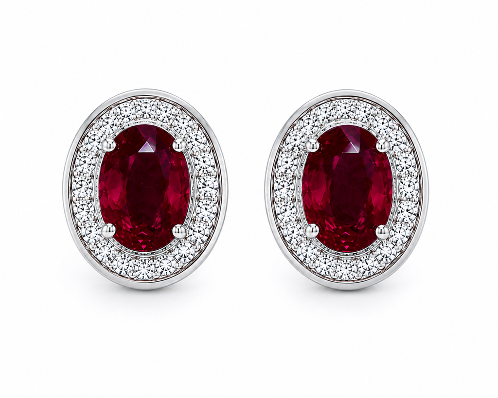 Natural 4x6mm oval ruby halo stud earrings in platinum plated 925 sterling silver with sparkling cubic zirconia on a white background.