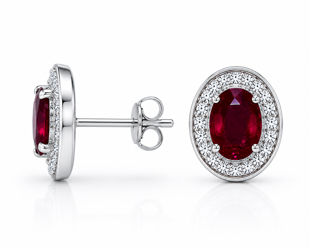 Natural 4x6mm oval ruby halo stud earrings in platinum plated 925 sterling silver with sparkling cubic zirconia on a white background.