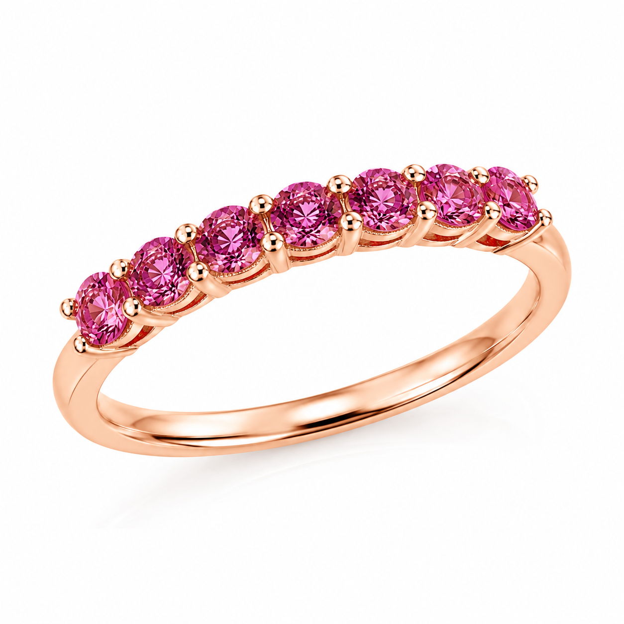 Natural Pink Garnet half eternity ring featuring seven genuine 3mm round pink garnets in rose gold plated 925 sterling silver on a white background.