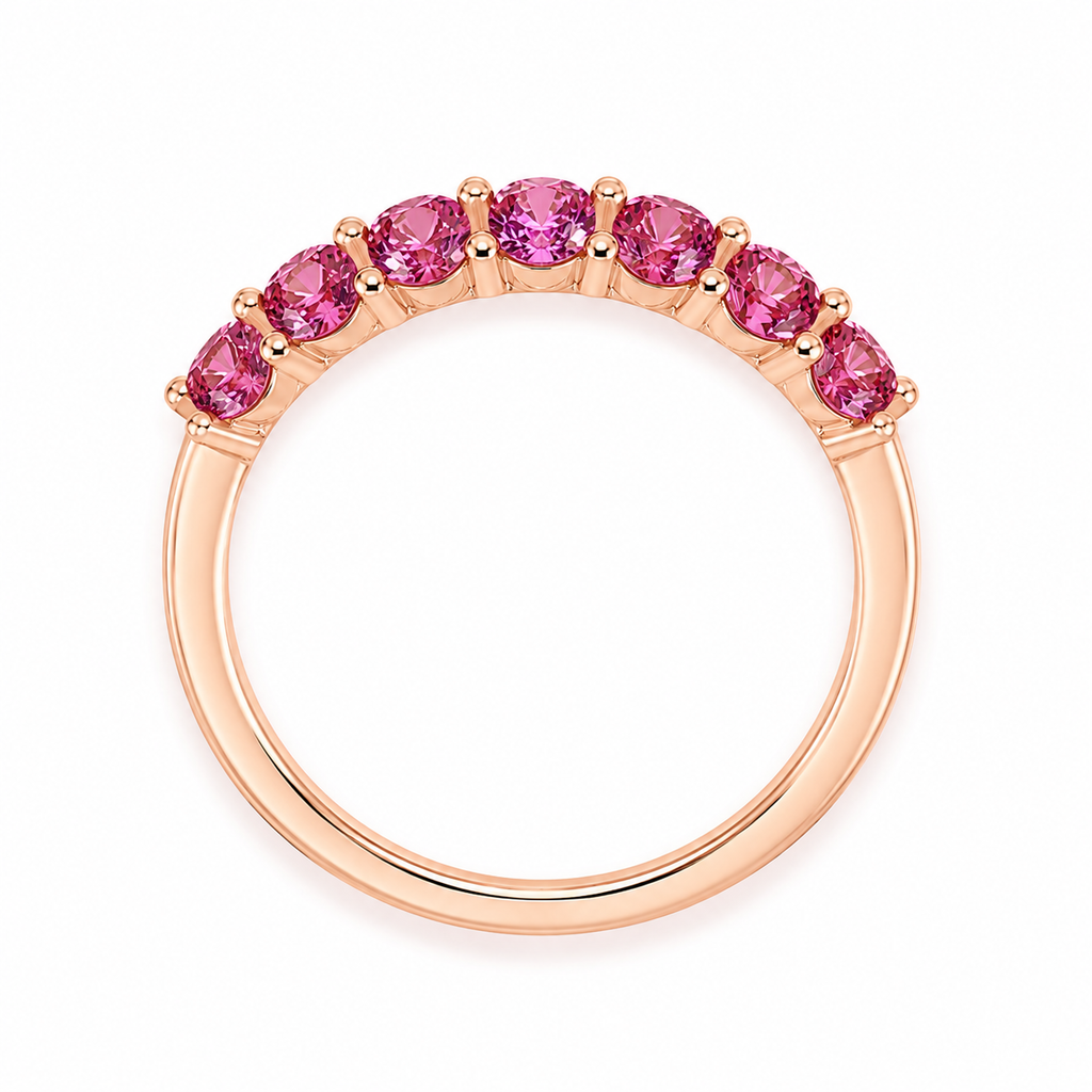 Natural Pink Garnet half eternity ring featuring seven genuine 3mm round pink garnets in rose gold plated 925 sterling silver on a white background.
