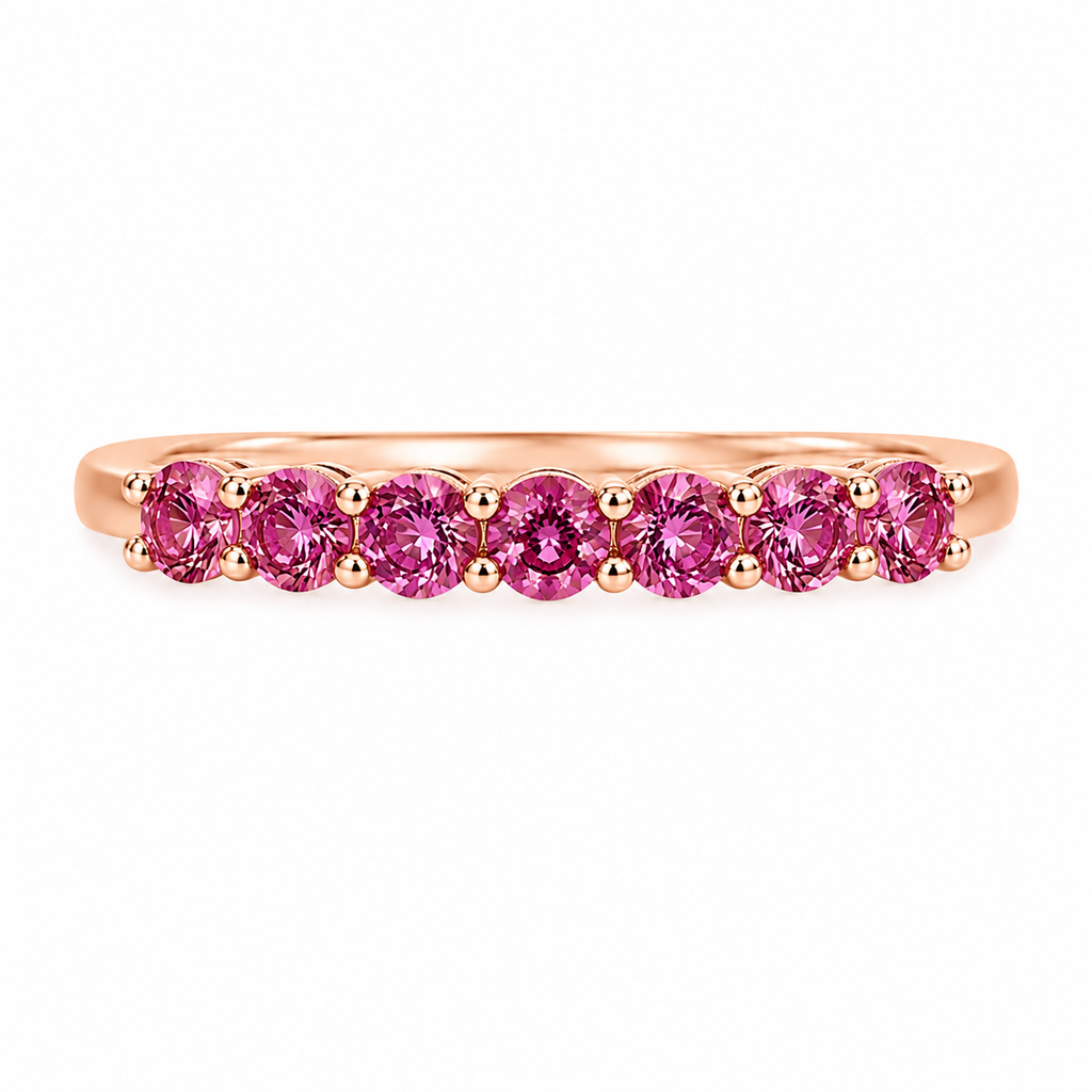 Natural Pink Garnet half eternity ring featuring seven genuine 3mm round pink garnets in rose gold plated 925 sterling silver on a white background.