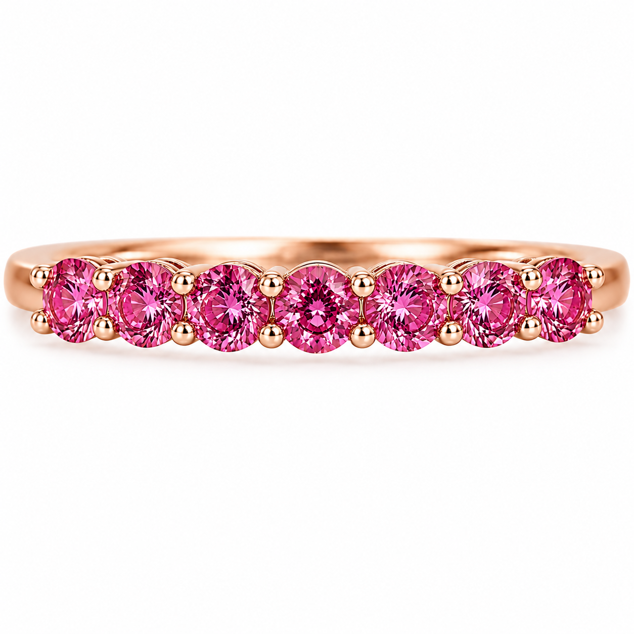 Natural Pink Garnet half eternity ring featuring seven genuine 3mm round pink garnets in rose gold plated 925 sterling silver on a white background.