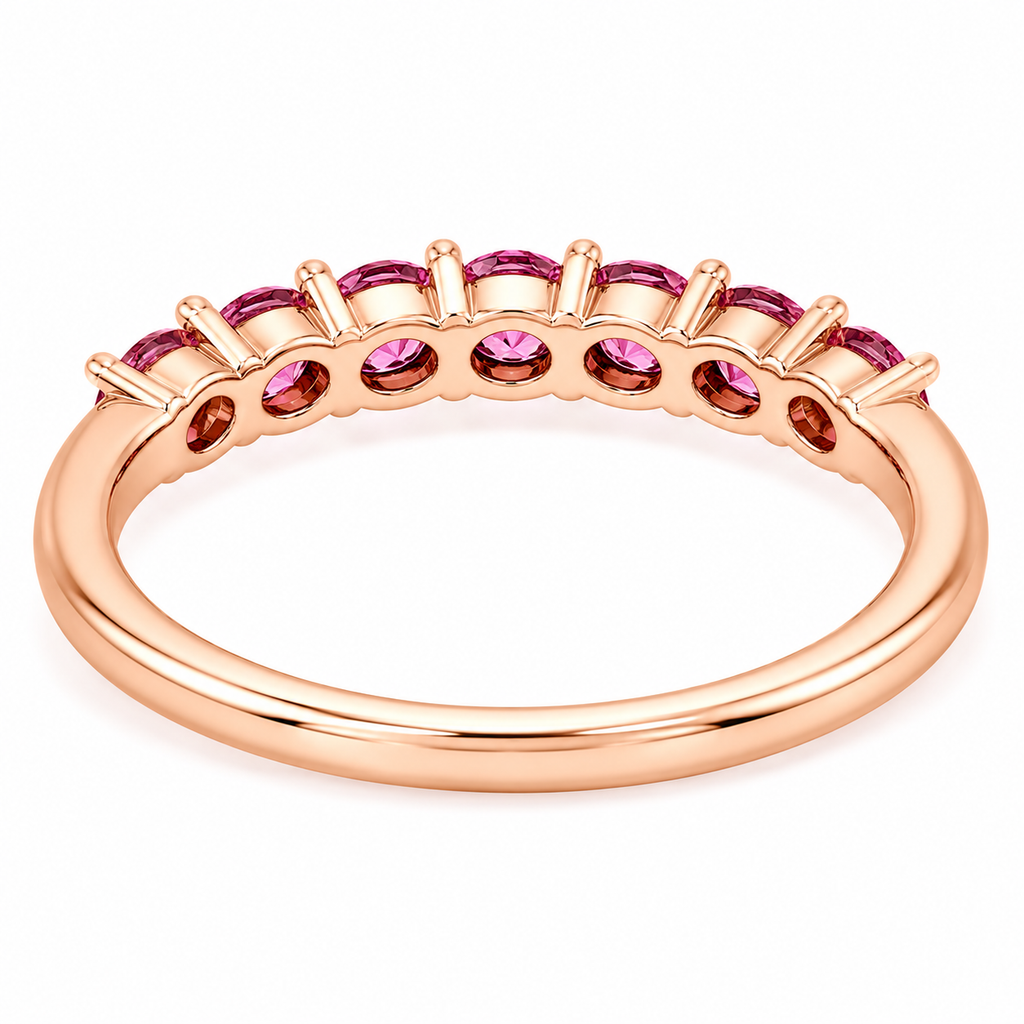 Natural Pink Garnet half eternity ring featuring seven genuine 3mm round pink garnets in rose gold plated 925 sterling silver on a white background.