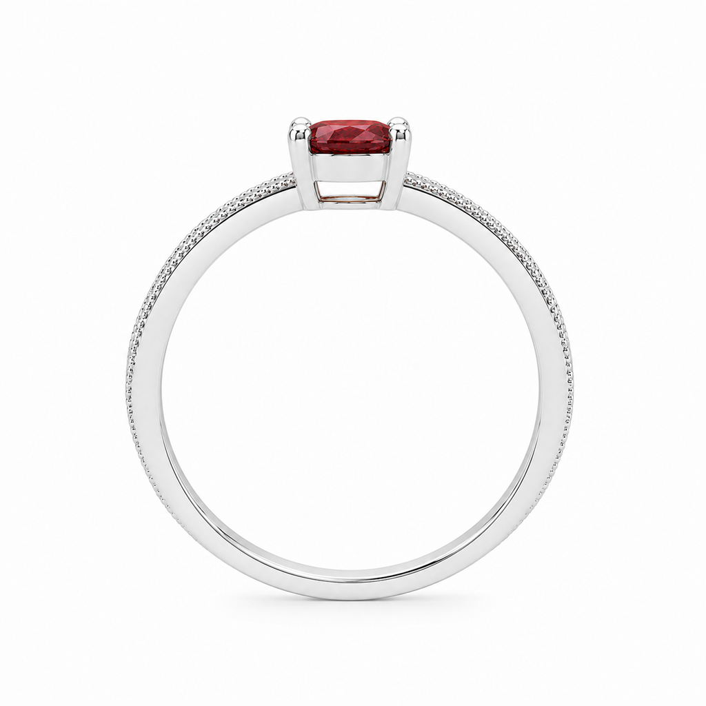 Natural 4×6mm oval red garnet ring crafted in platinum plated 925 sterling silver with vintage-inspired milgrain detailing and cubic zirconia accents on a white background.