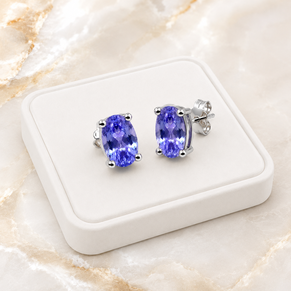 Natural Purple Tanzanite Halo Stud Earrings featuring 4x6mm oval genuine tanzanite gemstones in 925 sterling silver with sparkling cubic zirconia by Phimsera.