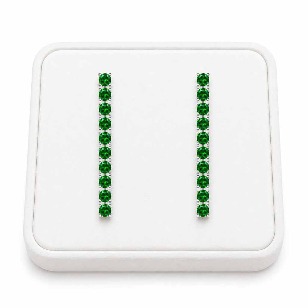 Phimsera natural chrome diopside dangle earrings displayed on a white velvet jewelry tray against a bright white background