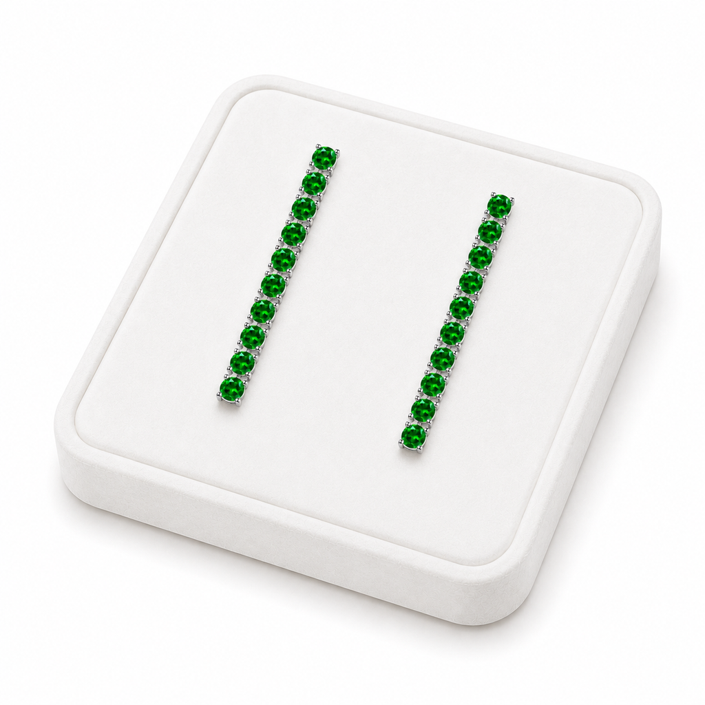 Phimsera natural chrome diopside dangle earrings displayed on a white velvet jewelry tray against a bright white background
