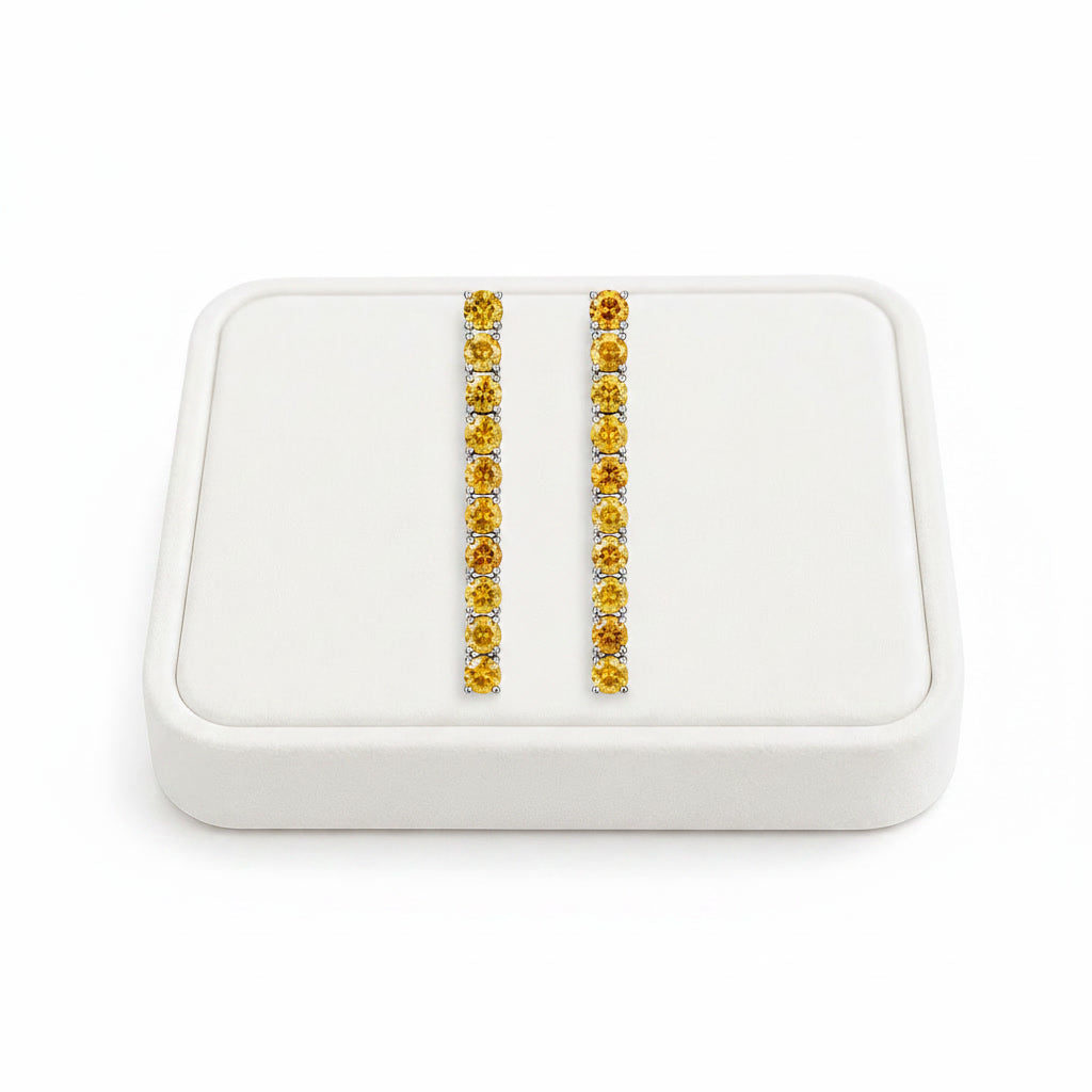 Phimsera natural citrine dangle earrings displayed on a white velvet jewelry tray against a bright white background