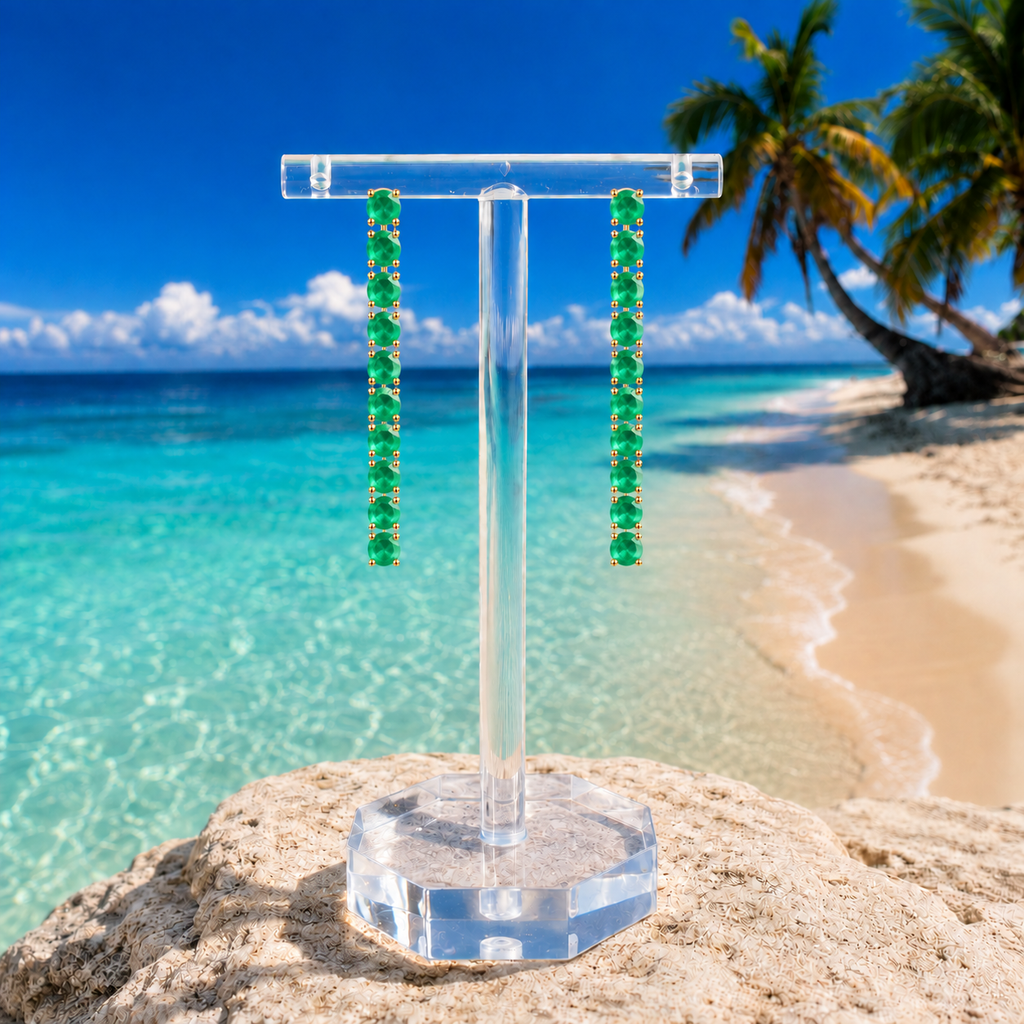 Phimsera natural green emerald dangle earrings styled in an elegant beach lifestyle setting