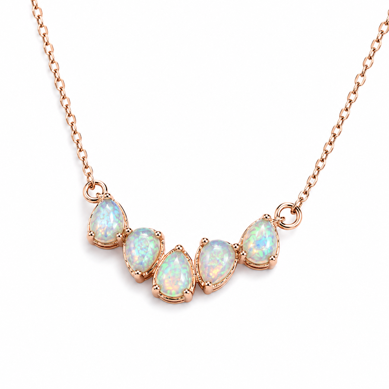 Macro view of natural 3x4mm Fire Opal gemstones in rose gold settings on delicate necklace