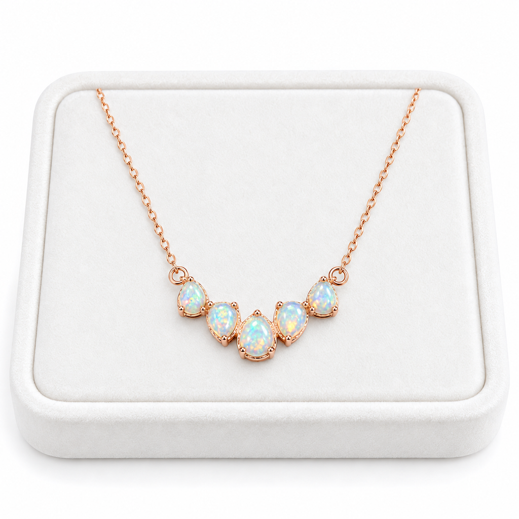 Natural Fire Opal clavicle chain necklace displayed on a white velvet jewelry tray
