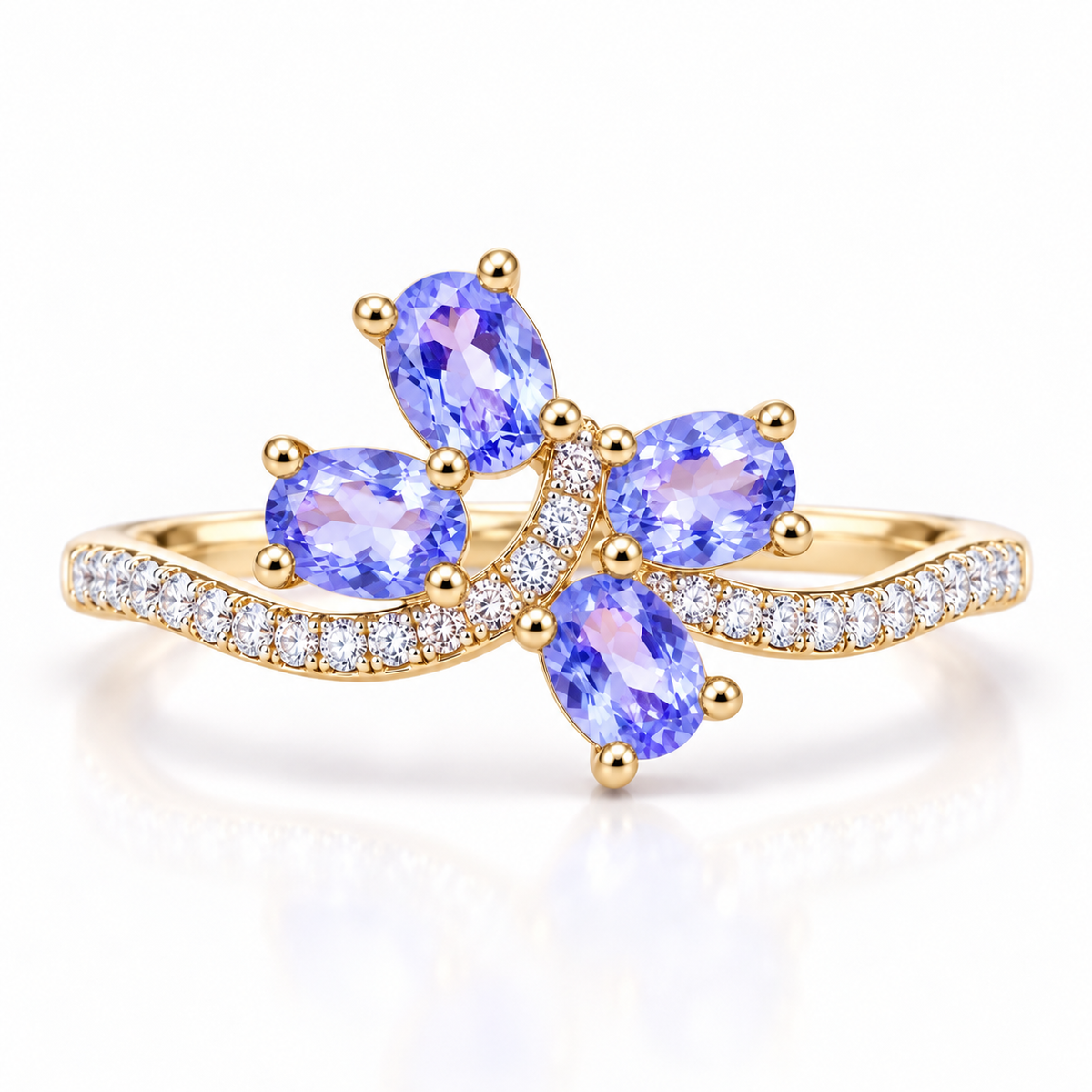 Natural purple tanzanite ring with four 3×4mm oval gemstones in an elegant floral-inspired design on a white background