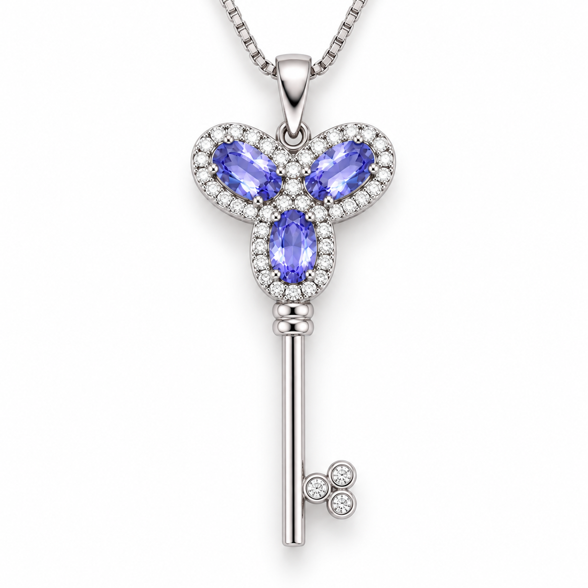 Top-down view of a natural purple tanzanite gemstone key-inspired pendant necklace in 925 Sterling Silver by Phimsera.