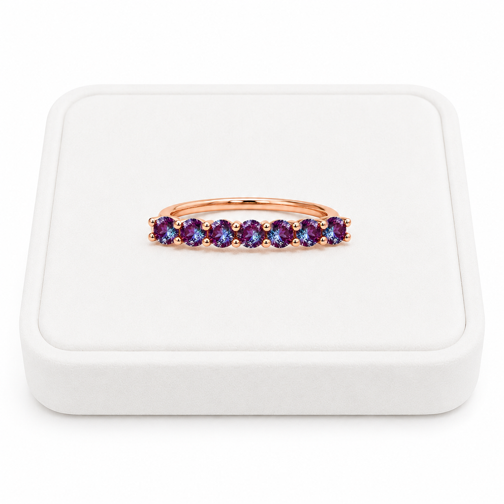 3mm lab alexandrite color changing band ring displayed on a white velvet jewelry tray