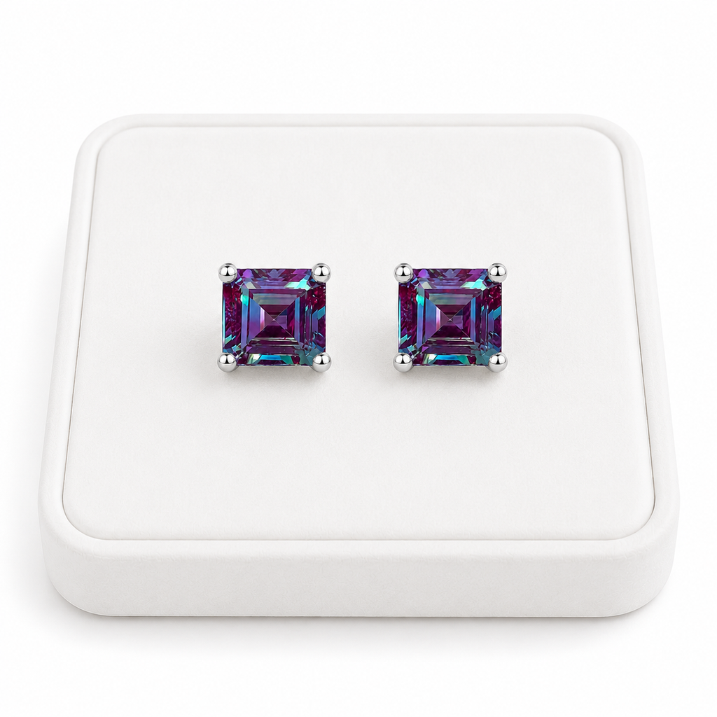 6mm Asscher cut lab alexandrite stud earrings displayed on a white velvet jewelry tray