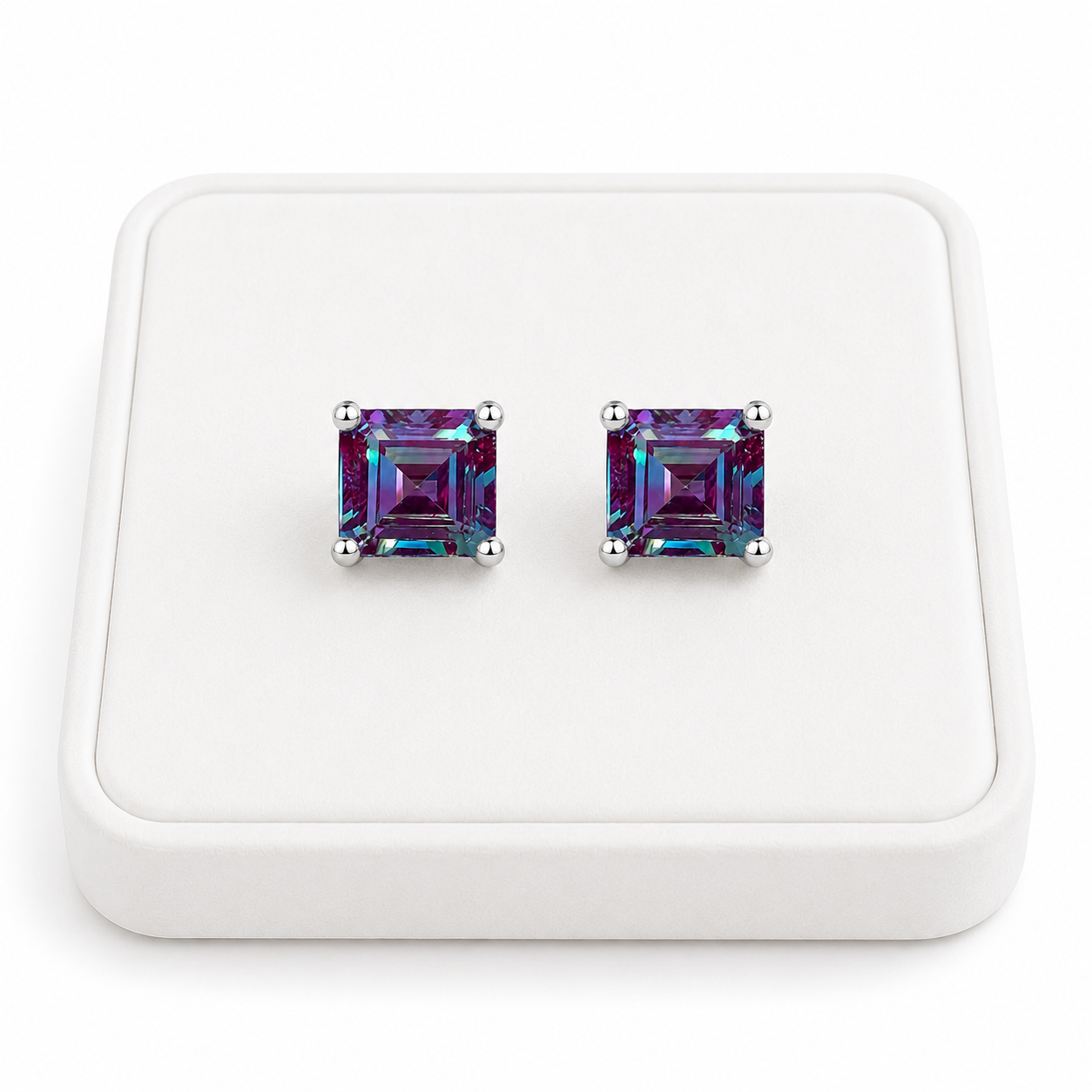 6mm Asscher cut lab alexandrite stud earrings displayed on a white velvet jewelry tray