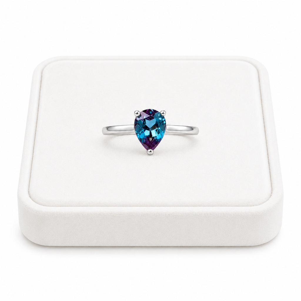 5x7mm pear cut lab alexandrite ring displayed on a white velvet jewelry tray