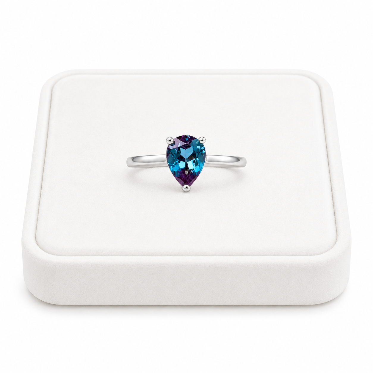 5x7mm pear cut lab alexandrite ring displayed on a white velvet jewelry tray