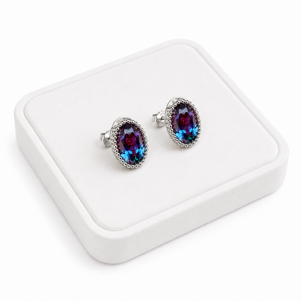 5x7mm oval lab-created alexandrite earrings displayed on a white velvet jewelry tray