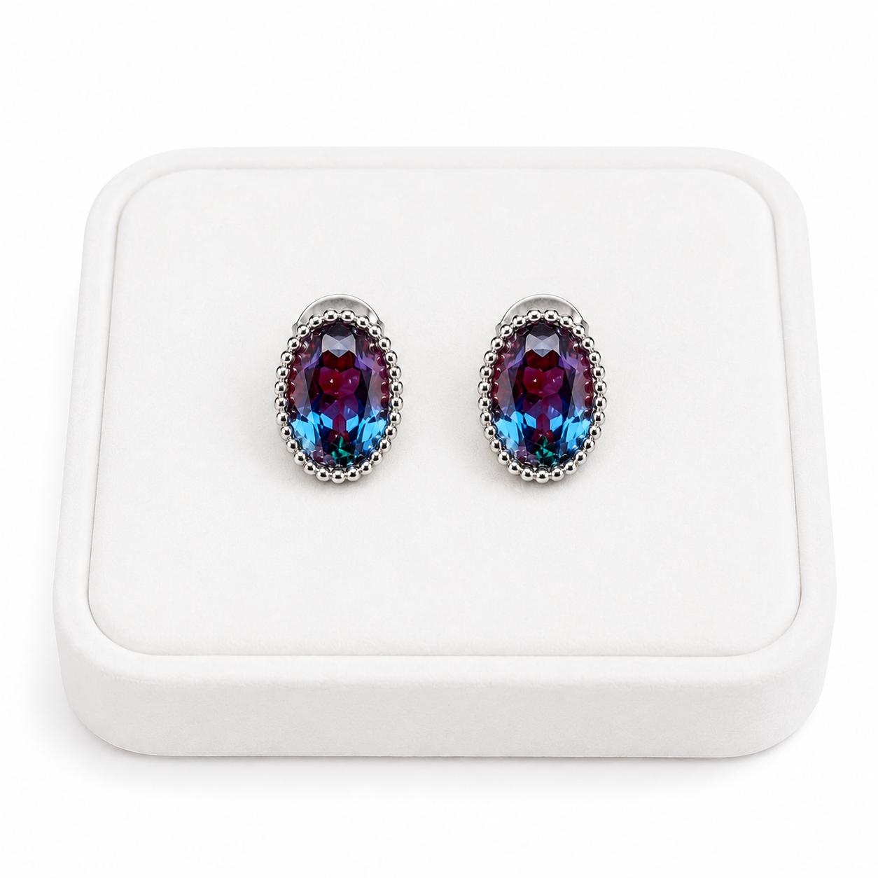 5x7mm oval lab-created alexandrite earrings displayed on a white velvet jewelry tray