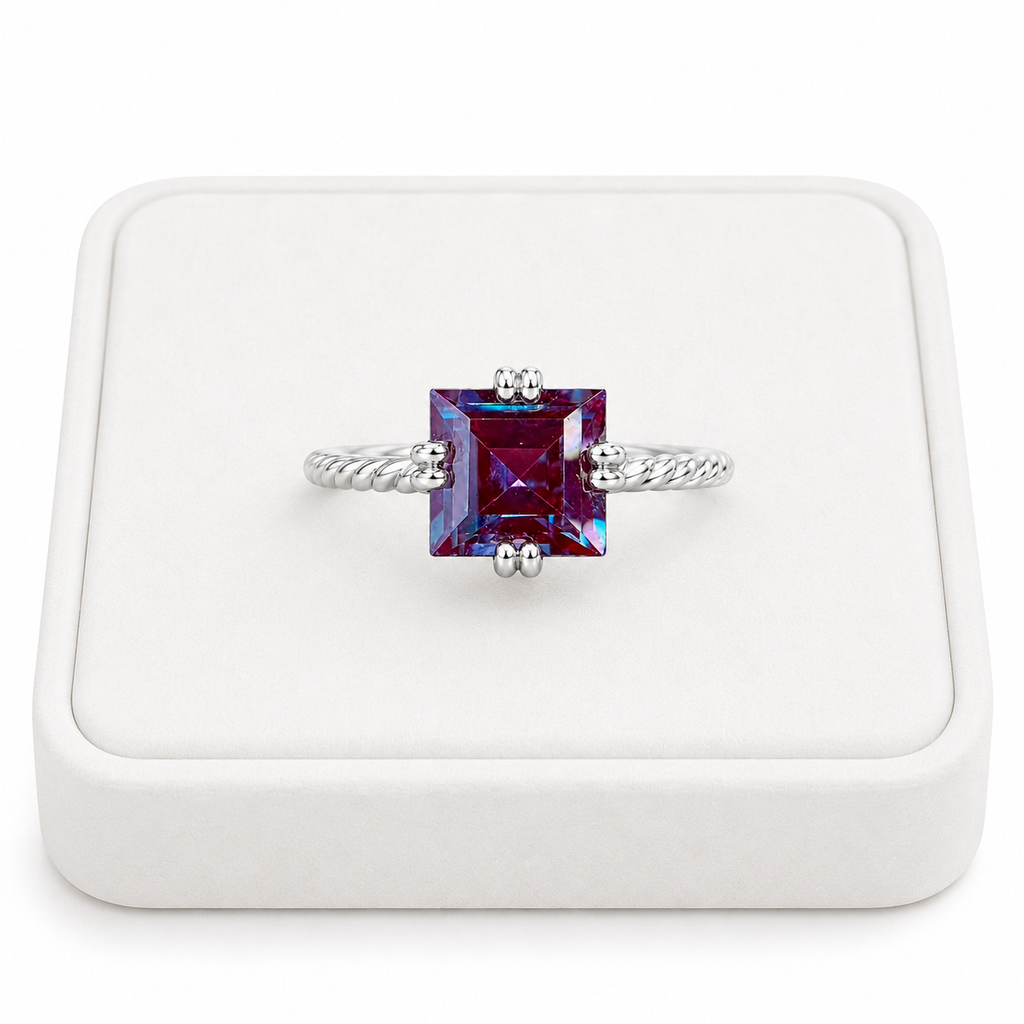 7mm square cut lab alexandrite ring displayed on a white velvet jewelry tray