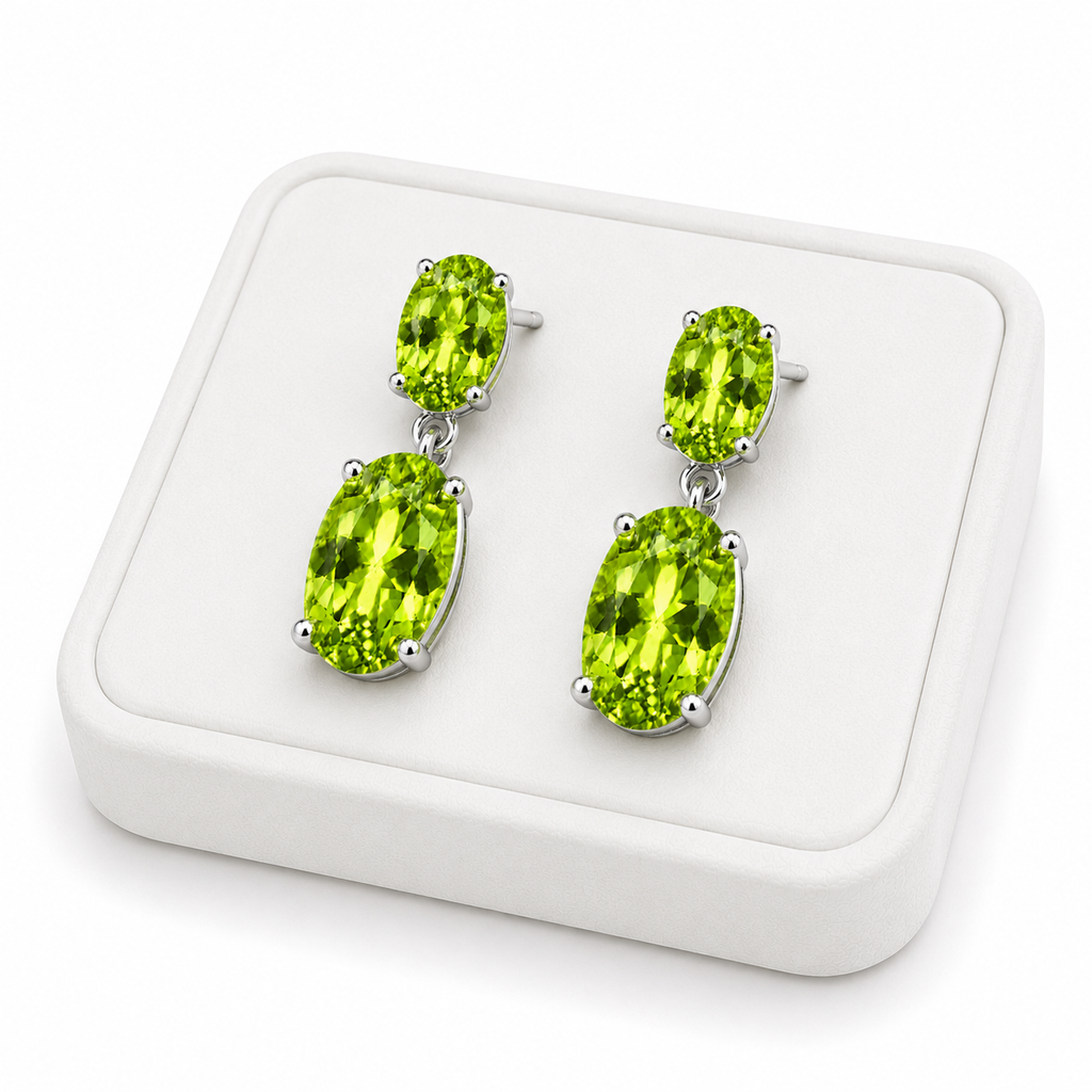 Natural peridot dangle earrings displayed on a white jewelry tray