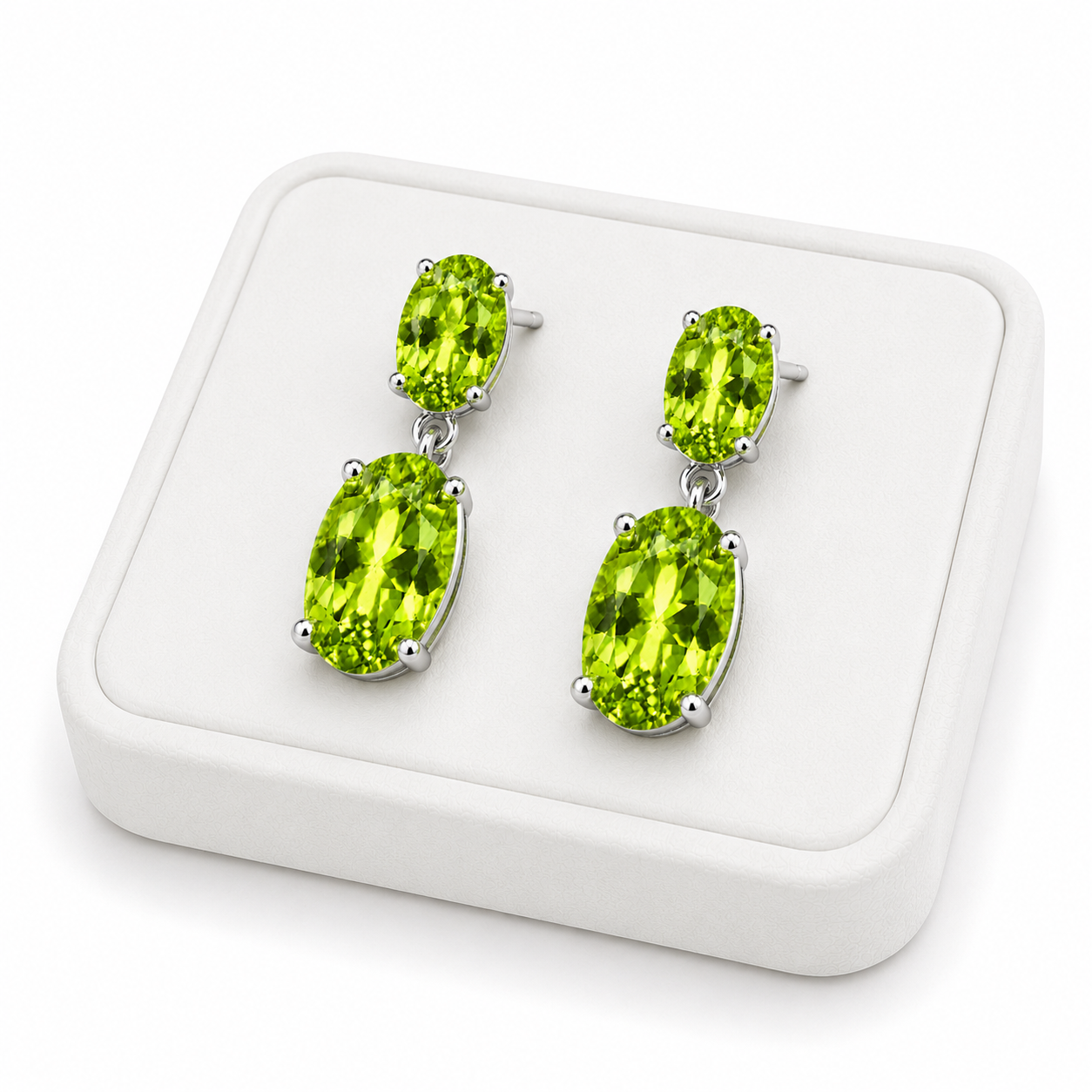 Natural peridot dangle earrings displayed on a white jewelry tray