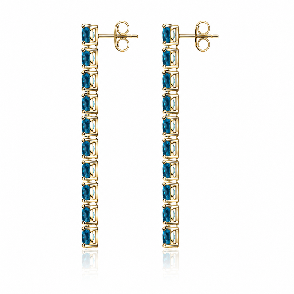 Side view of Phimsera London Blue Topaz dangle earrings showing the elongated vertical gemstone design and sterling silver settings