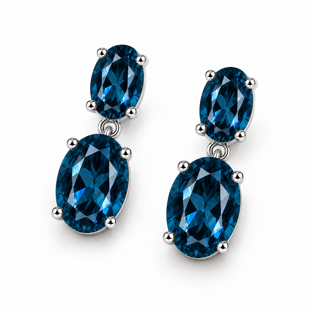 Angled London Blue Topaz dangle earrings with deep blue oval gemstones and sterling silver settings