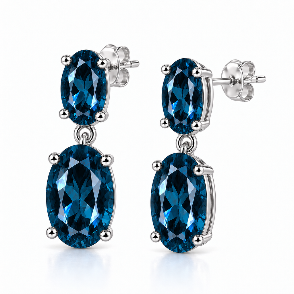 Side view of London Blue Topaz dangle earrings with oval gemstones and sterling silver settings
