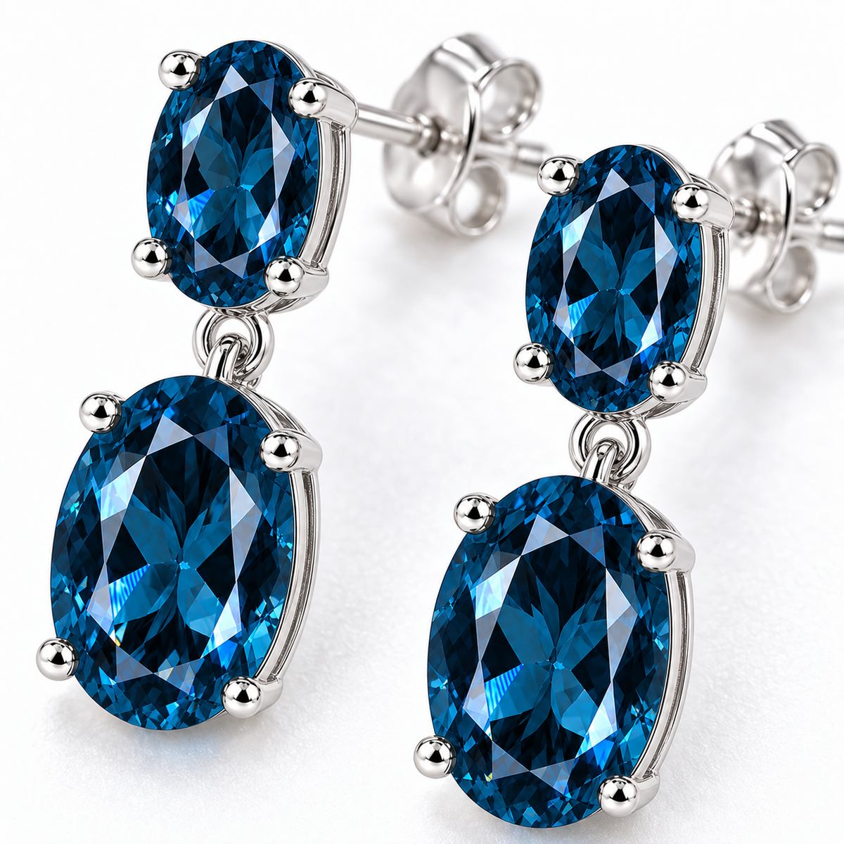 Macro view of faceted London Blue Topaz gemstones in elegant sterling silver dangle earrings