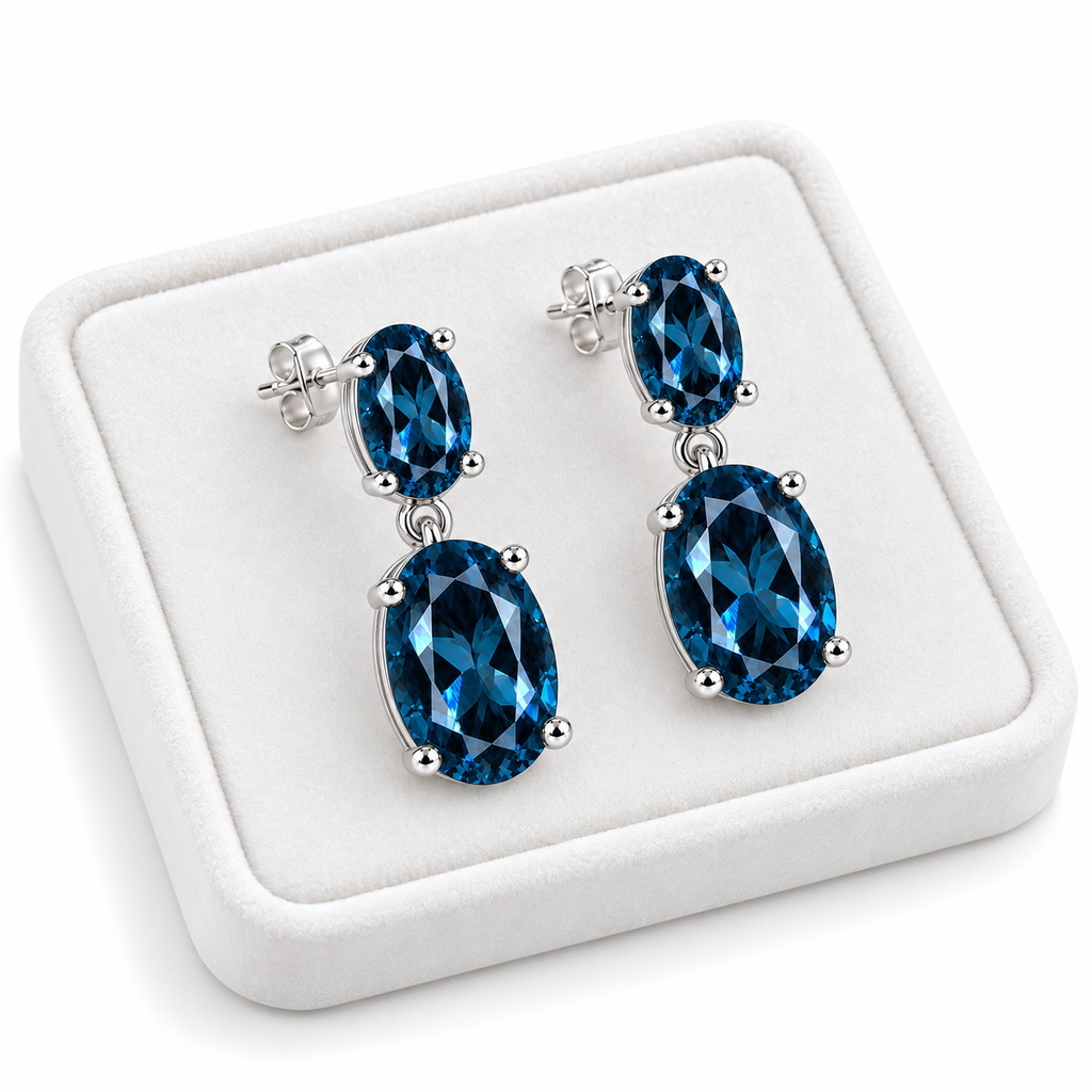 London Blue Topaz dangle earrings displayed on a white velvet jewelry tray