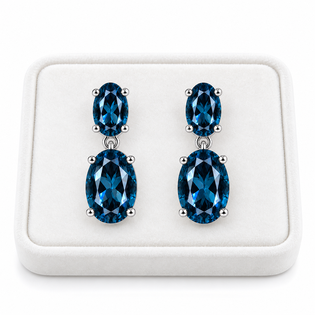 London Blue Topaz dangle earrings displayed on a white velvet jewelry tray
