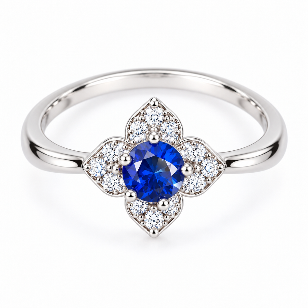 Top-down view of a natural 3.5mm round blue sapphire ring with four-petal floral halo and sparkling accent stones