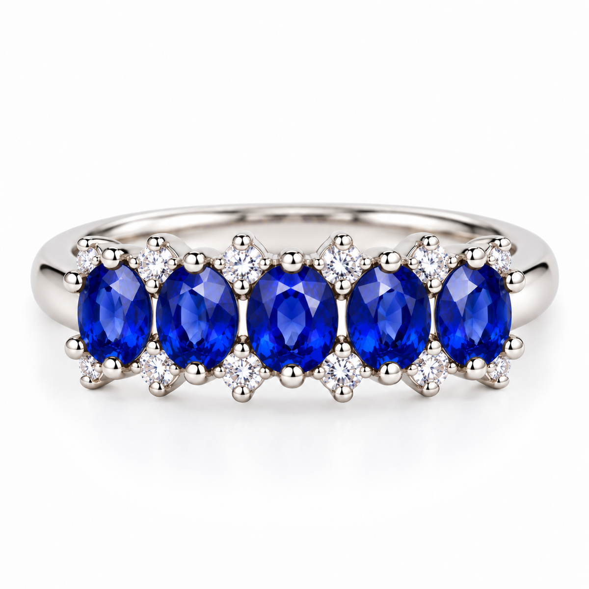 Top-down view of a natural blue sapphire band ring featuring 3×4mm oval sapphire gemstones in 925 Sterling Silver