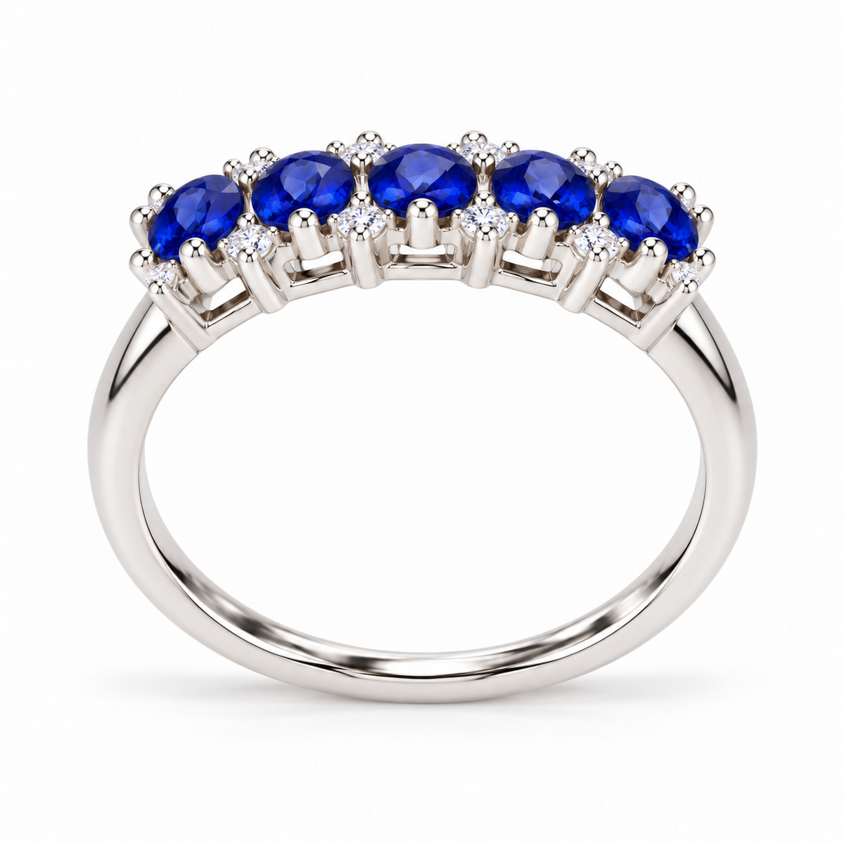 Side profile of a natural 3×4mm blue sapphire band ring showing the gemstone settings and polished Sterling Silver band