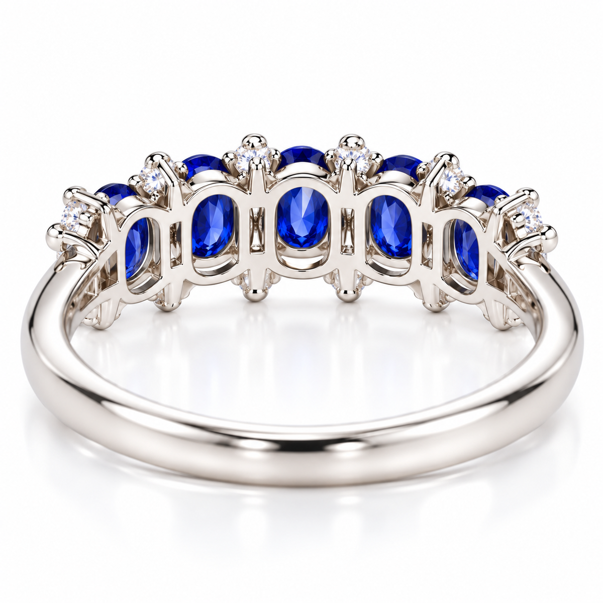 Detailed underside view of a natural blue sapphire band ring showing the gemstone settings and 925 Sterling Silver construction