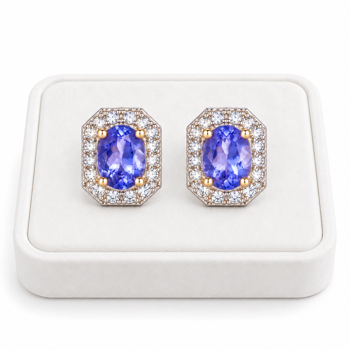 Phimsera 4×5mm natural purple tanzanite earrings displayed on a white velvet jewelry tray against a clean white background.