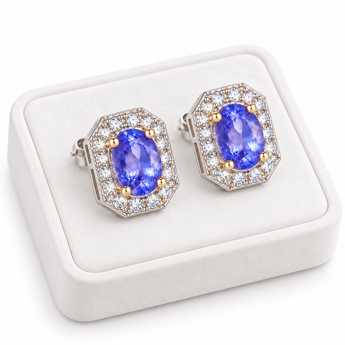 Phimsera 4×5mm natural purple tanzanite earrings displayed on a white velvet jewelry tray against a clean white background.